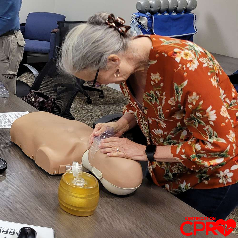 CPR training session with adult mannequin in West Palm Beach.