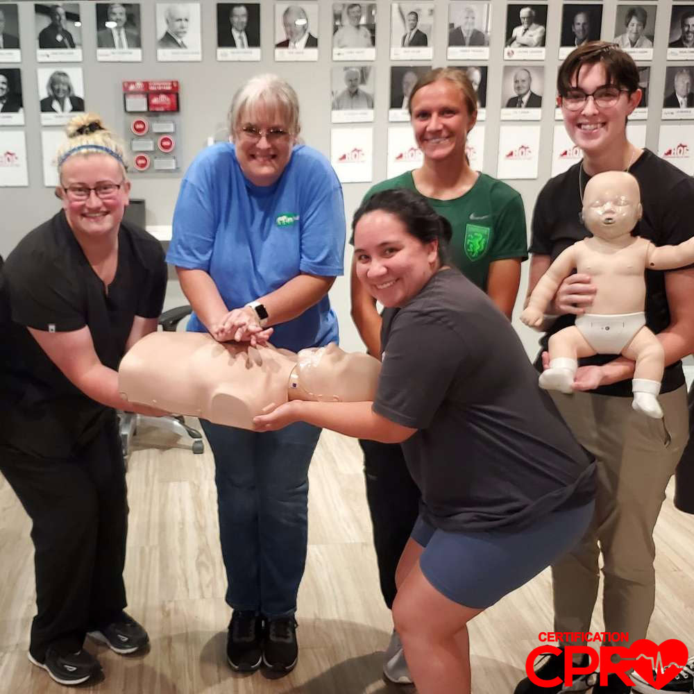 CPR training class in West Palm Beach with students practicing on mannequins.